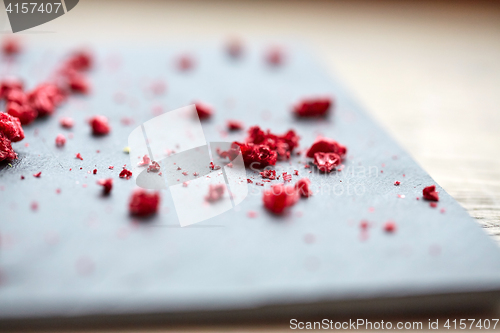 Image of dried raspberries or berries on stone plate