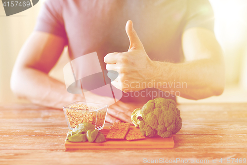 Image of close up of male hands showing food rich in fiber