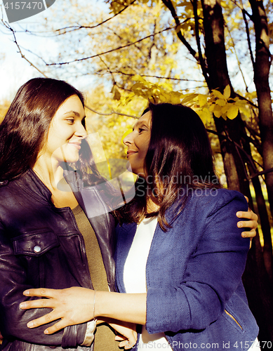Image of mature real mother with daughter outside autumn fall in park