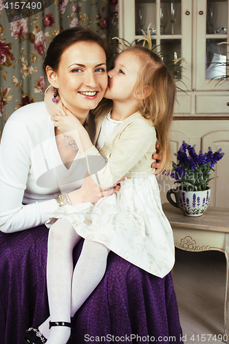 Image of young mother with daughter at luxury home interior vintage