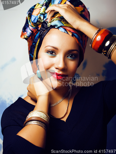 Image of beauty bright african woman with creative make up, shawl on head