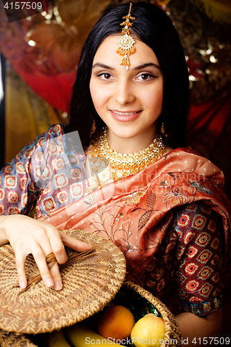 Image of beauty sweet real indian girl in sari smiling on black background