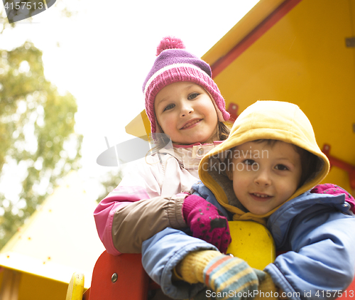 Image of little cute boy and girl playing outside, adorable friendship