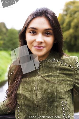 Image of Enjoying the nature. Young woman enjoying the fresh air in green