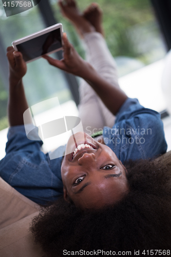 Image of african american woman at home with digital tablet