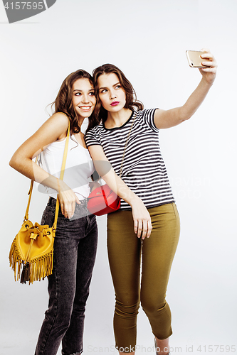 Image of two best friends teenage girls together having fun, posing emotional on white background, besties happy smiling, making selfie, lifestyle people concept