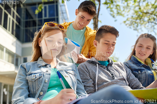 Image of group of students with notebooks at school yard