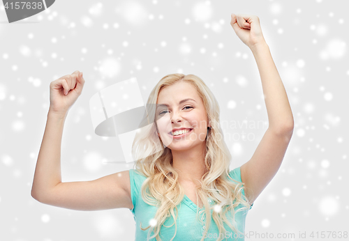 Image of happy young woman or teen girl celebrating victory