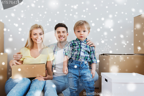 Image of happy family with boxes moving to new home