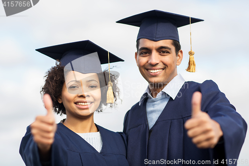 Image of happy students or bachelors showing thumbs up