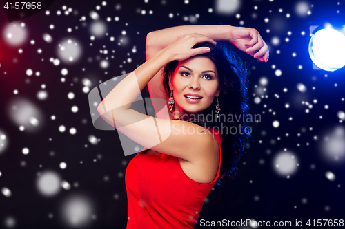 Image of beautiful sexy woman in red dancing at nightclub