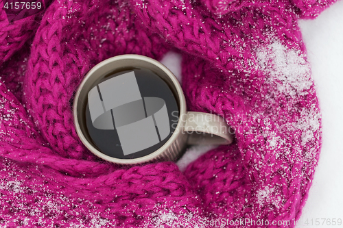 Image of close up of tea or coffee and winter scarf in snow