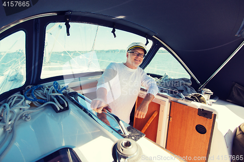 Image of happy senior man on boat or yacht sailing in sea