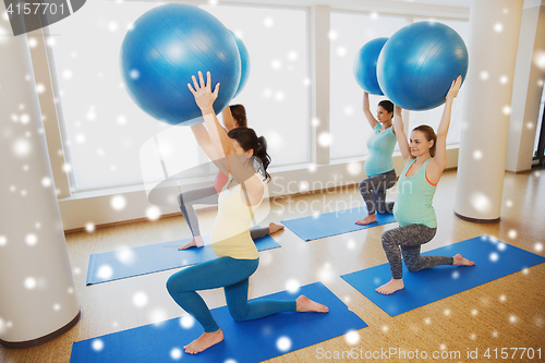 Image of happy pregnant women with exercise balls in gym