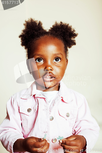 Image of little cute african american girl playing with animal toys at ho