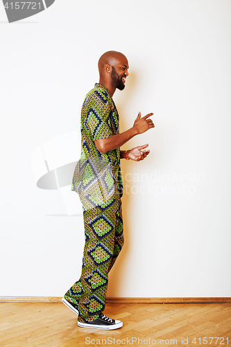 Image of portrait of young handsome african man wearing bright green nati