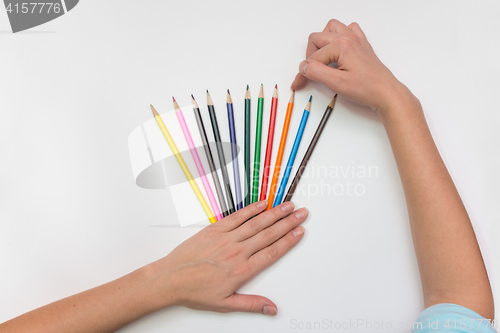 Image of She chooses the correct pencil, close-up top