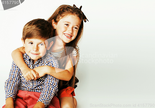 Image of little cute boy and girl hugging playing on white background, ha