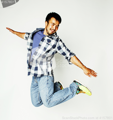 Image of young pretty asian man jumping cheerful against white background