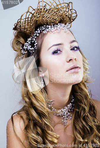 Image of beauty young snow queen with hair crown on her head, complicate 