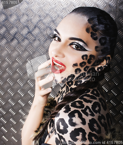 Image of young sexy woman with leopard make up all over body, cat bodyart