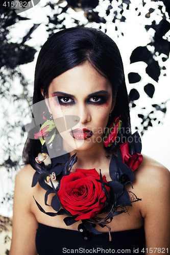 Image of pretty brunette woman with rose jewelry, black and red, bright m