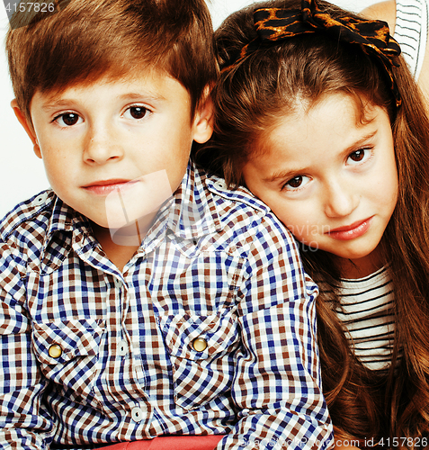 Image of little cute boy and girl hugging playing on white background, ha