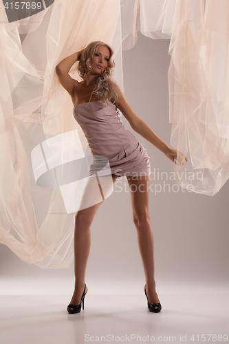 Image of Young beautiful woman in fashionable dress