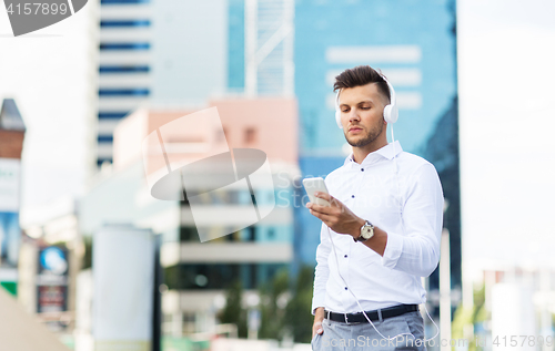 Image of man with headphones and smartphone listening music