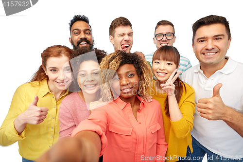 Image of international group of happy people taking selfie