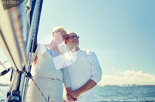 Image of senior couple hugging on sail boat or yacht in sea