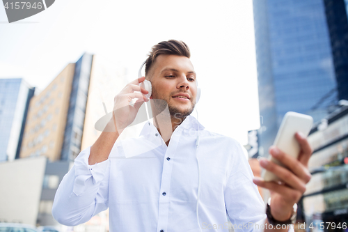 Image of man with headphones and smartphone listening music