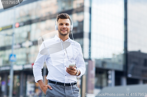 Image of man with headphones and smartphone listening music