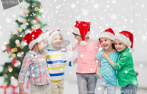 Image of happy little children in christmas santa hats