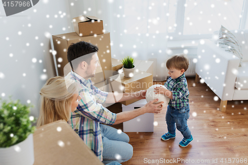 Image of happy family moving to new home and playing ball