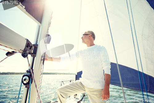 Image of senior man on sail boat or yacht sailing in sea