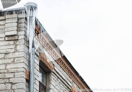 Image of icicles hanging from building roof and drainpipe