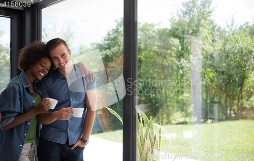 Image of romantic happy young couple relax at modern home indoors