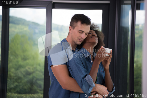 Image of romantic happy young couple relax at modern home indoors