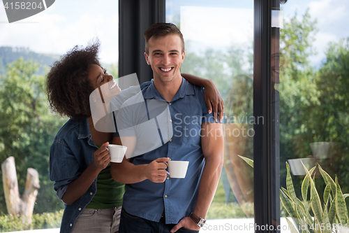 Image of romantic happy young couple relax at modern home indoors