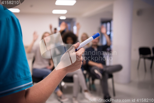 Image of close up of teacher hand with marker