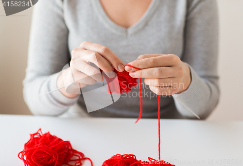 Image of woman hands knitting with needles and yarn