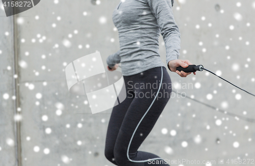 Image of close up of woman exercising with jump-rope