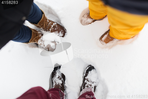 Image of group of people feet on snow