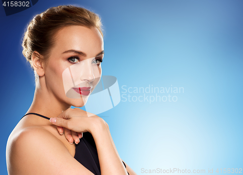 Image of beautiful woman in black over blue background