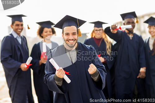 Image of happy student with diploma celebrating graduation