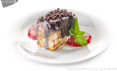 Image of biscuit cake with chocolate and strawberry sauce