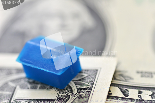 Image of Little plastic house on US dollar banknote