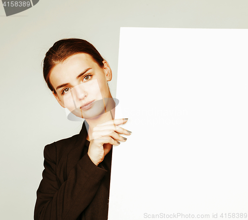 Image of young pretty brunette girl with placard on white background wear