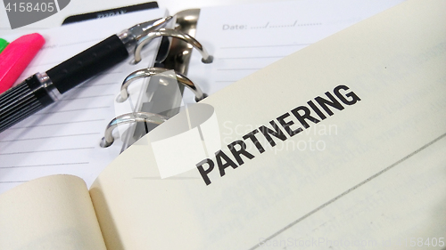 Image of Partnering word printed on white book